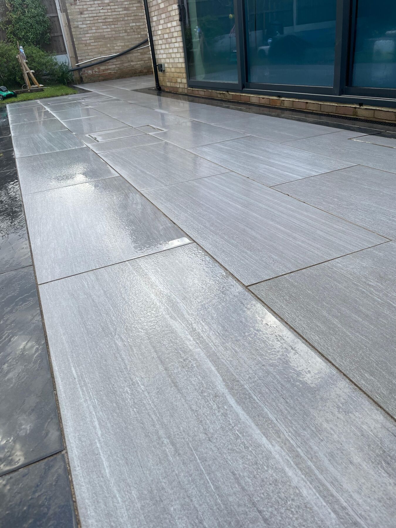 Large porcelain patio cleaned to a bright, streak-free finish by K.A.D Exterior Cleaning